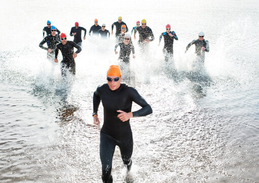 Triathletes emerging from water