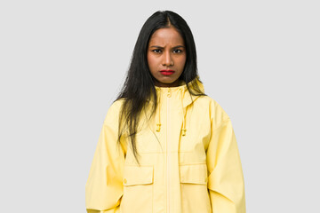 Young Indian woman cut out isolated on white background sad, serious face, feeling miserable and displeased.