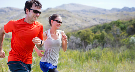 Couple running in rural landscape