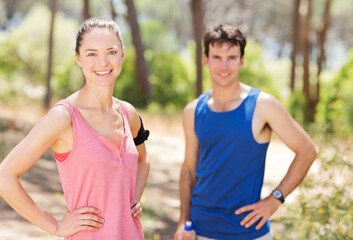 Couple resting during workout outdoors