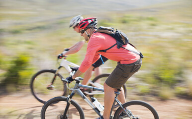 Blurred view of mountain bikers on dirt path