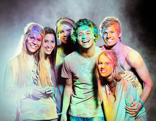 Fototapeta premium Portrait of friends covered in chalk dye at music festival