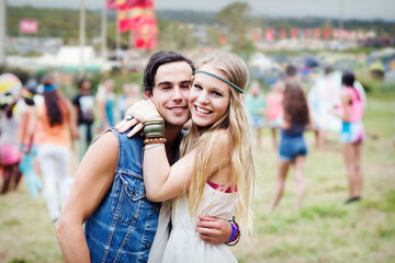 Portrait of couple hugging at music festival