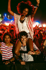 Cheering woman on man shoulders at music festival - obrazy, fototapety, plakaty