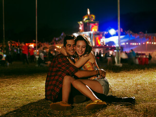 Happy couple hugging outside music festival