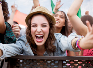 Close up of cheering woman at music festival