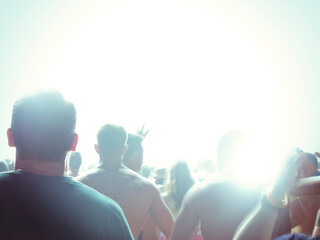 Silhouette of fans facing illuminated stage