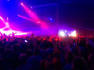Crowd facing illuminated stage