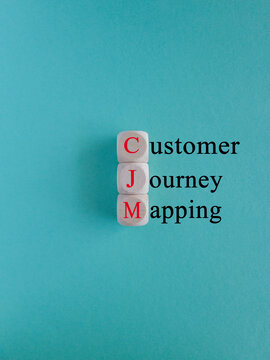 CJM customer journey mapping symbol. Concept red words CJM customer journey mapping on wooden cubes on a beautiful light blue background. Business and CJM customer journey mapping concept. Copy space.