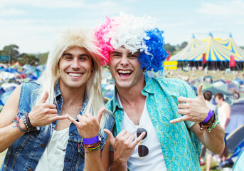 Portrait of men in wigs gesturing at music festival
