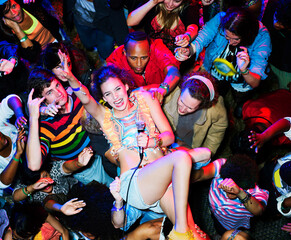 Portrait of enthusiastic performer crowd surfing at music festival