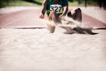 Long jumper landing in sand