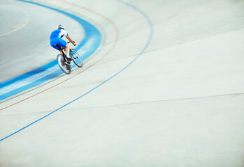 Track cyclist riding around velodrome - obrazy, fototapety, plakaty
