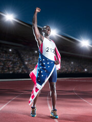 Fototapeta premium Track and field athlete wrapped in American flag on track
