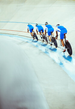 Track cycling team riding in velodrome