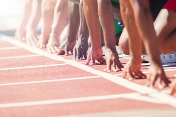 Runners poised at starting blocks on track