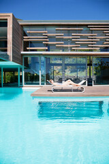Woman sunbathing on lounge chair at poolside