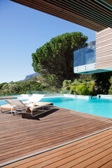Luxury swimming pool and lounge chairs on deck
