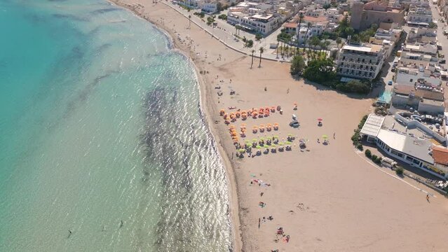 Aerial drone view on the beach and umbrellas in San Vito Lo Capo, Italy