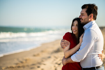 Romantic couple hugging on the beach