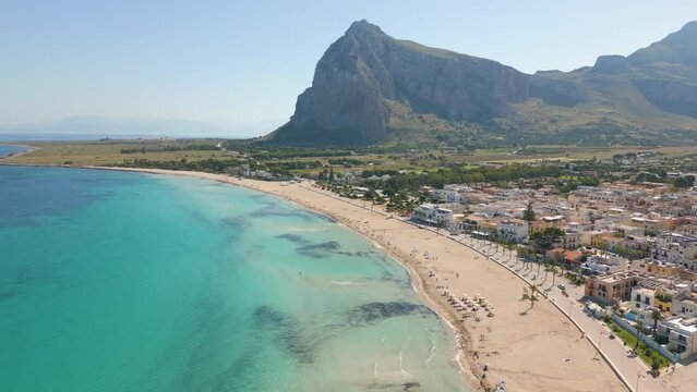 This aerial drone video shows the town of San Vito Lo Capo in Northern Sicily, Italy. The mediterranean town has a beautiful beach. 