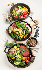 Healthy vegetarian and vegan  salads and Buddha Bowls with vitamins, antioxidants, protein on light  background.