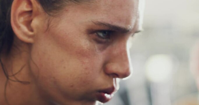 Tired, cycling and fitness with face of woman at gym for workout, weight loss or endurance training. Breathing, sweat and fatigue with girl in spin class for sports, health and cardio challenge