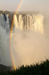 rainbow over Victoria falls. Zambeze river.
