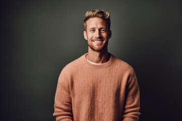 Fototapeta premium Medium shot portrait photography of a glad boy in his 30s wearing a cozy sweater against a minimalist or empty room background. With generative AI technology