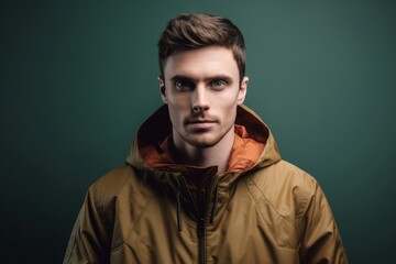 Fototapeta premium Medium shot portrait photography of a glad boy in his 30s wearing a lightweight windbreaker against a minimalist or empty room background. With generative AI technology