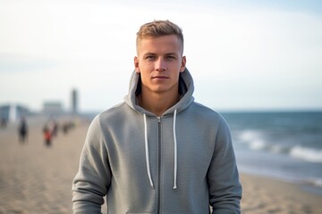 Environmental portrait photography of a satisfied boy in his 30s wearing a stylish hoodie against a beach background. With generative AI technology