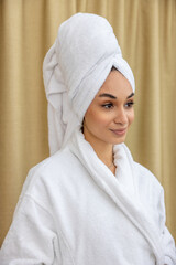 Cute young woman in a bathrobe after shower