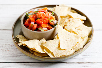 Tomato salsa with tortilla chips.