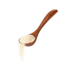White sesame seeds falling from wooden spoon isolated on white background
