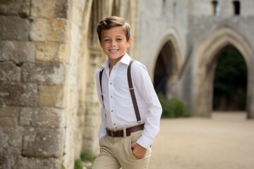 Fototapeta na wymiar Lifestyle portrait photography of a grinning kid male wearing a smart pair of trousers against a medieval castle background. With generative AI technology