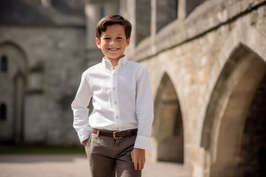 Lifestyle portrait photography of a grinning kid male wearing a smart pair of trousers against a medieval castle background. With generative AI technology