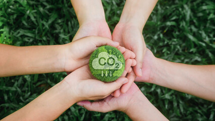 in hand holding green earth on green background Carbon neutral concept, reducing CO2 emissions for the environment, global warming, sustainable development. and green business from renewable energy