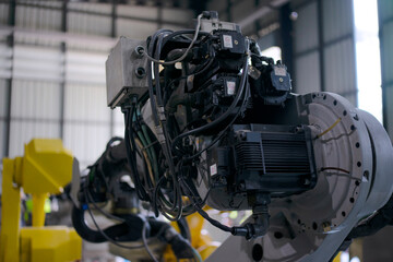 Engineer work at robotic arm factory.