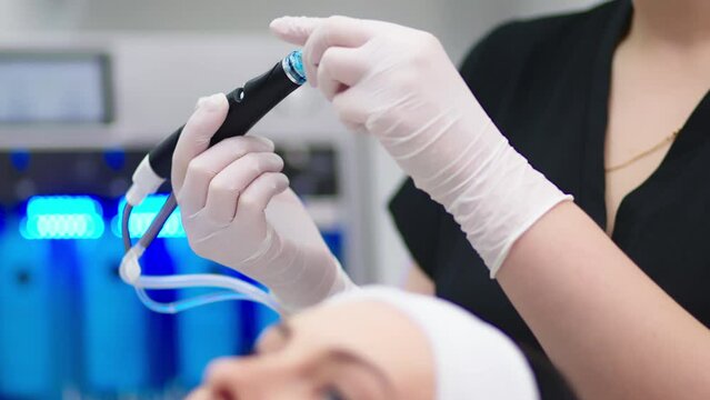 Perfect cleansing. Face of a beautiful pleasant woman being cleansed during hydrafacial procedure