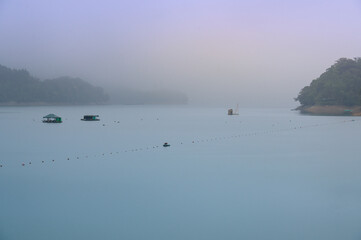 Dynamic clouds and wispy fog, delicate ripples on the lake. Sun Moon Lake in the early morning. It is like a dream, a fantasy, a mystery.