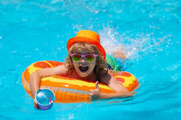 Excited kids face. Boy kid swimming and playing in a pool. Child playing in swim pool. Summer fashion kids portrait. Vacation in a tropical resort. Swimwear for children. Summer rest and relaxation.