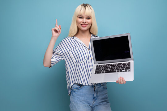 Business Concept. Joyful Cute Blond 25 Year Old Female Person In Striped Blouse Offers Promotional Offer On Laptop Screen