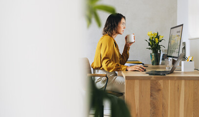 Productive businesswoman planning marketing campaign with coffee in office