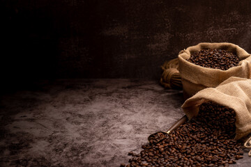 The picture of coffee beans stacked together on a wooden floor in a warm, light atmosphere, on a...