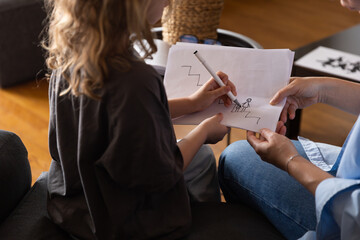 A girl at a psychologist's appointment draws a test drawing, low self-esteem and psychological...