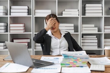Asian business women are stressed while working on laptop and pile of documents, Tired asian businesswoman with headache at office, feeling sick at work