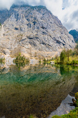 Fototapeta na wymiar Mirror-smooth Obersee with reflections of the majestic mountain world (Berchtesgaden, Bavaria, Germany) 
