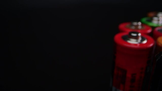 Detailed macro shot of spent alkaline batteries, typically found in TV remote controls and flashlights. Captured against a black backdrop.