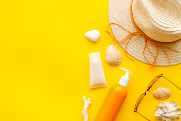Sunprotection set with sunscreen cosmetic and straw hat. Summer beach concept flatlay