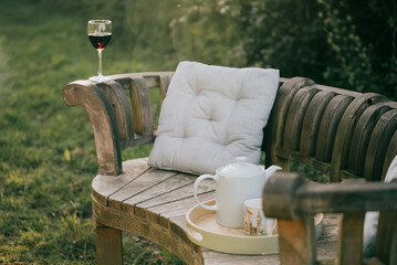 Wine and Tea on a chair in the garden